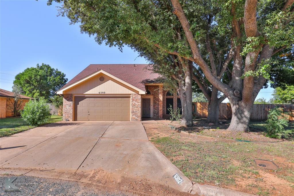 a view of a house with a yard and garage