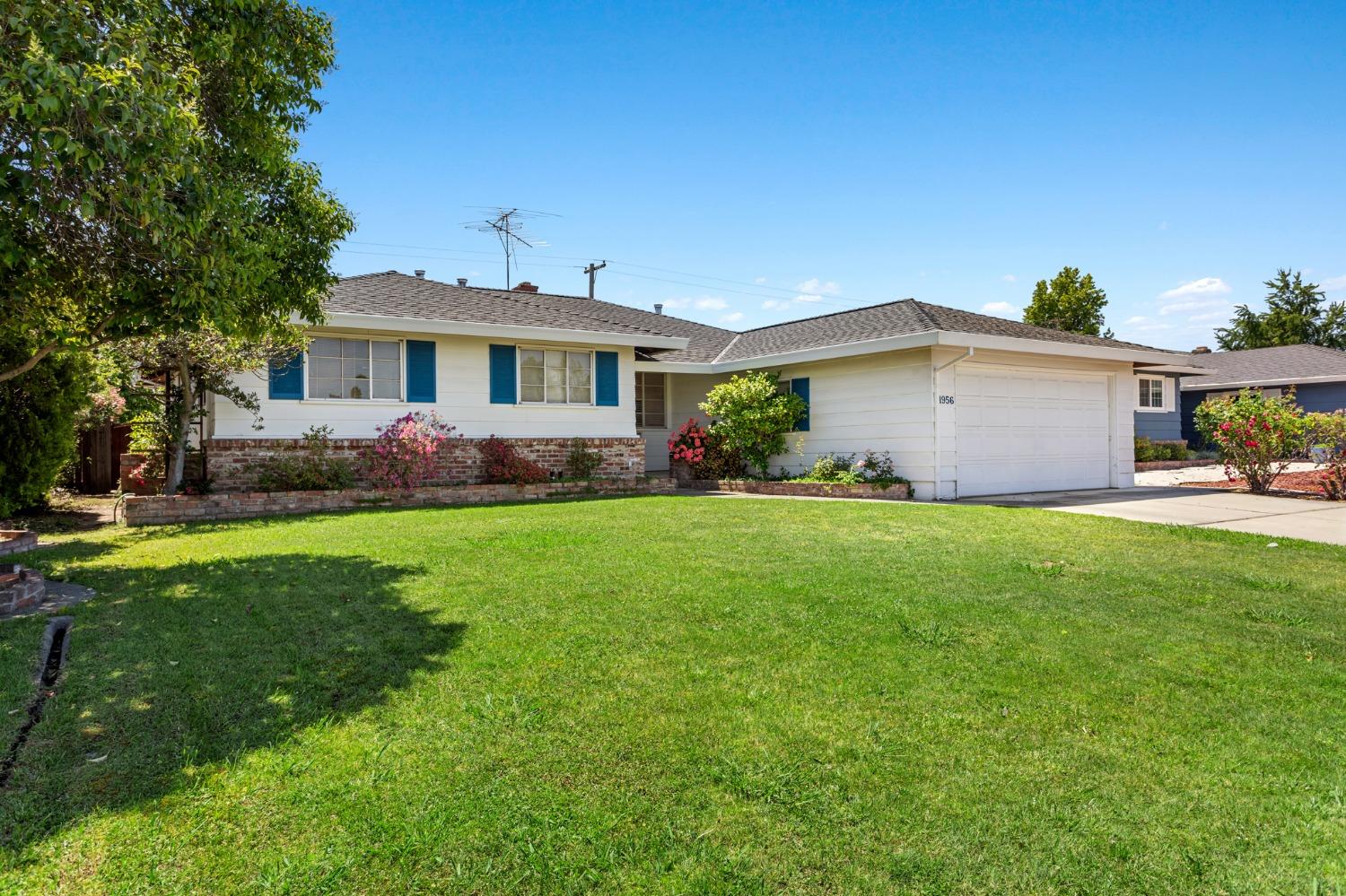 a front view of house with yard and green space