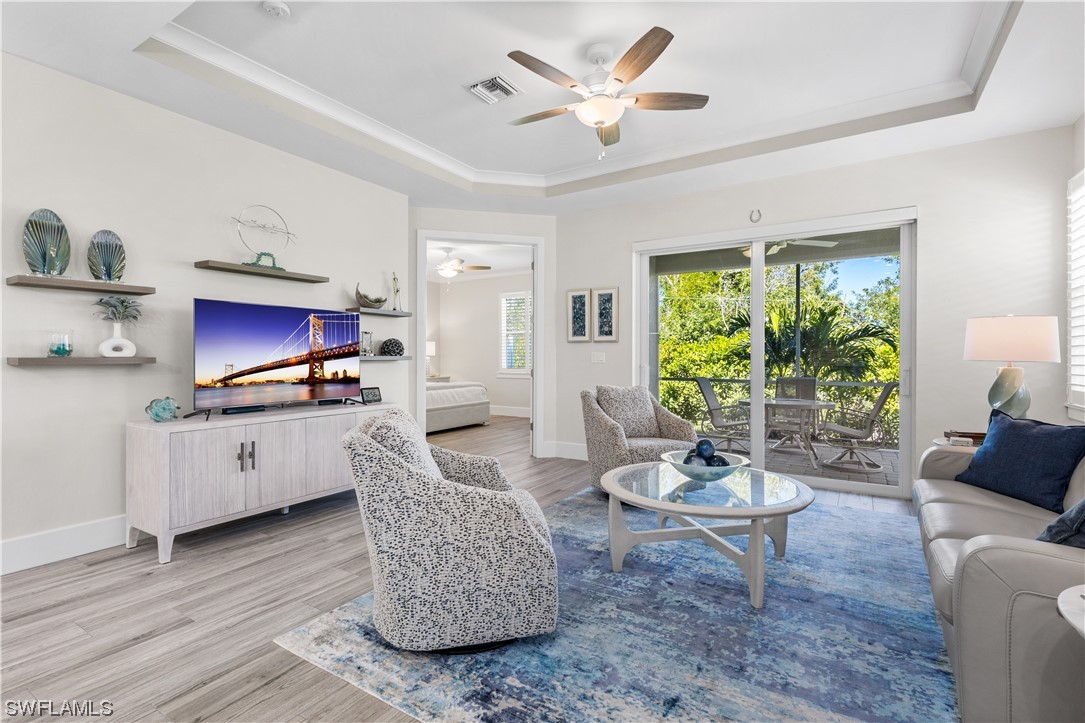 a living room with furniture a window and a flat screen tv