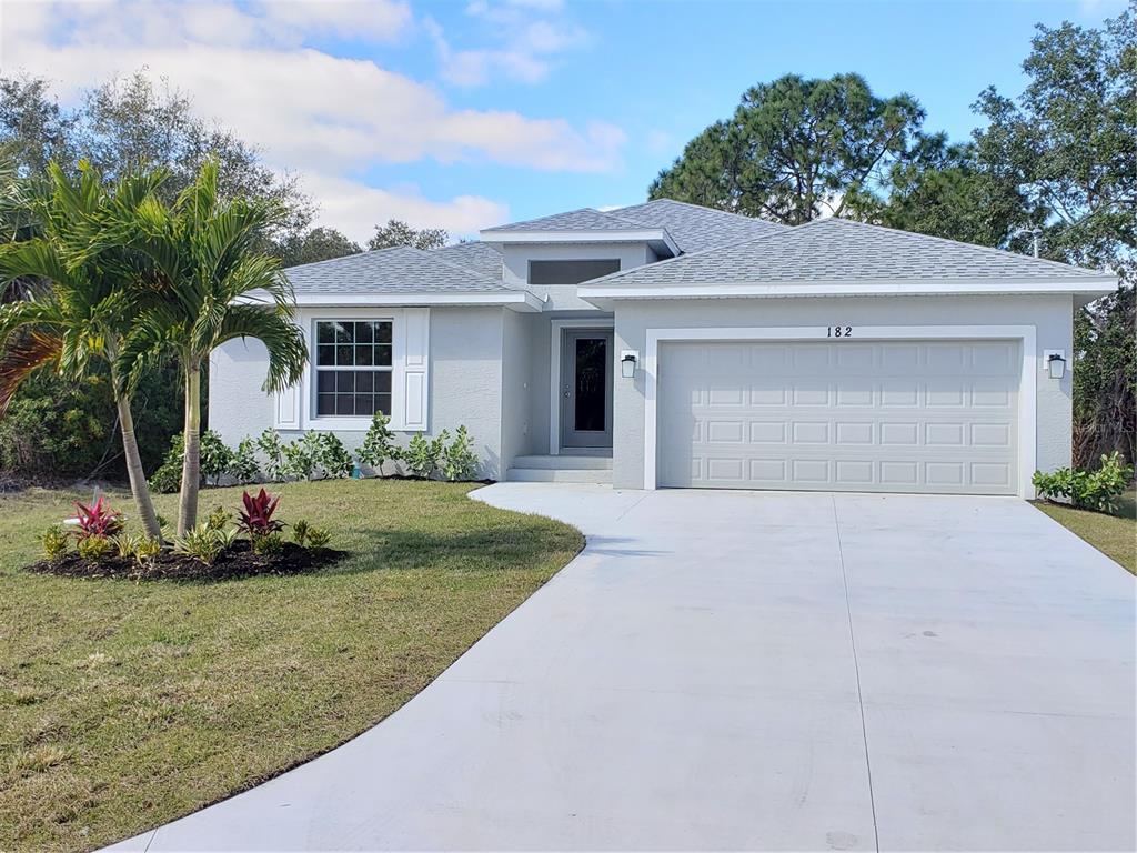 a front view of a house with a yard and garage