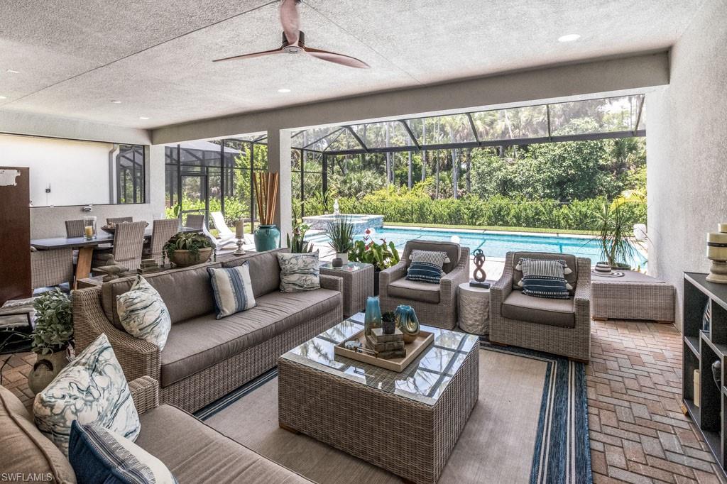 Living room with ceiling fan and a textured ceiling