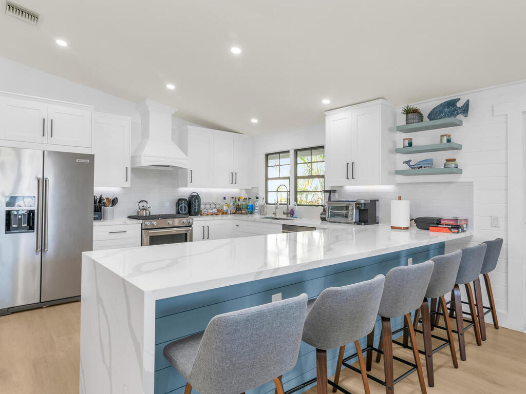 a kitchen with a dining table cabinets appliances and a counter top space