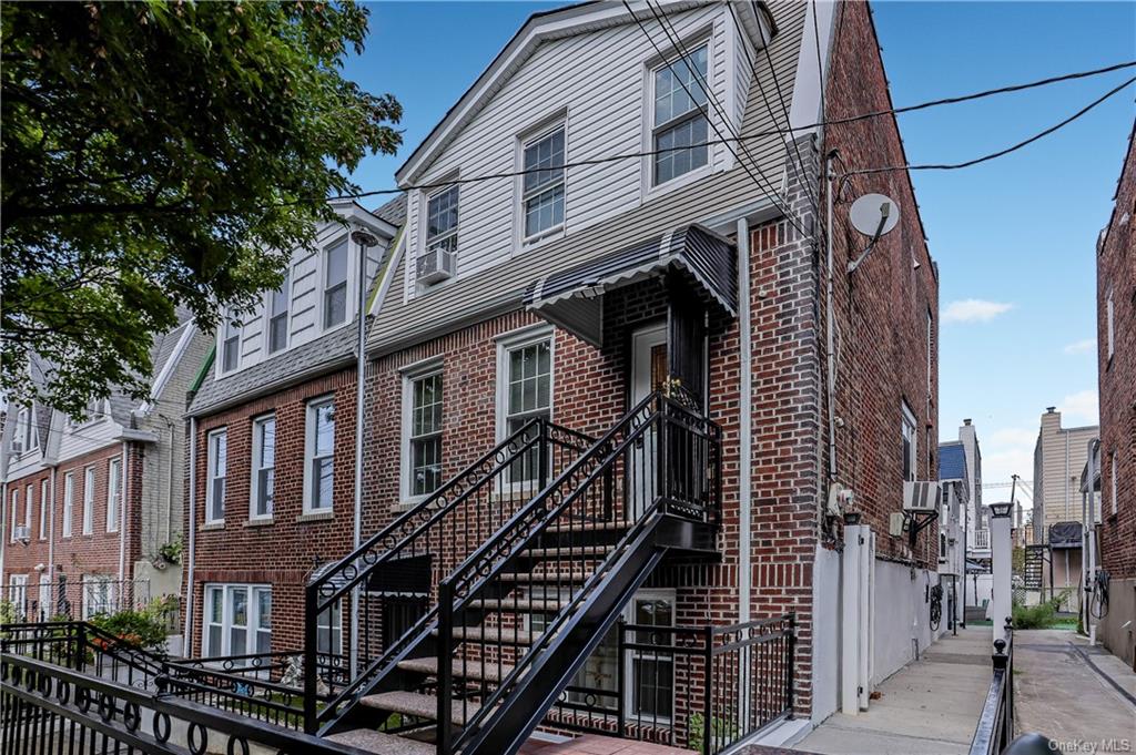 View of front entrance to the property featuring wrought iron style stairs with private access to the corridor leading to the back of the property with additional back yard space for your private enjoyment.