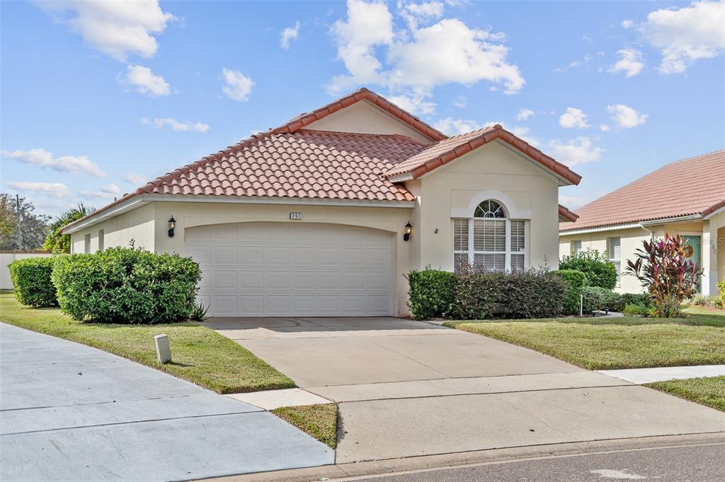 a front view of a house with a yard and garage