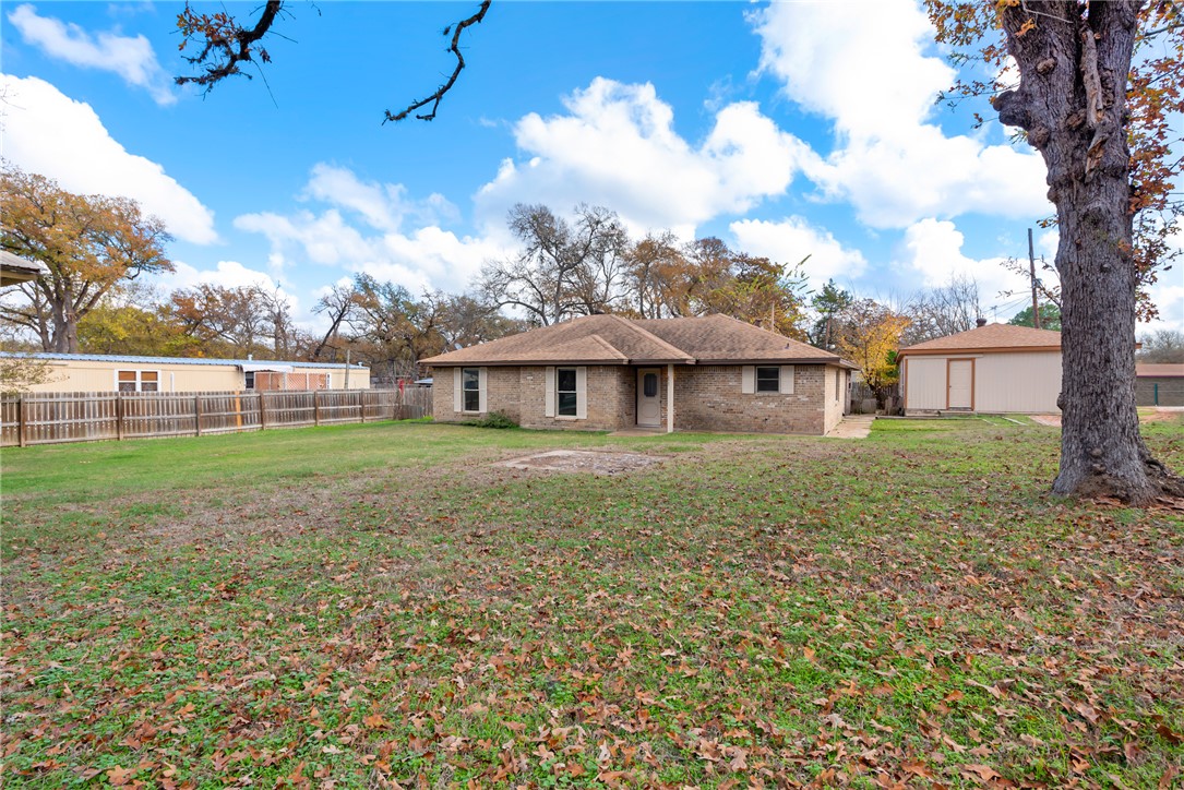 Rear view of house with an outdoor structure and a