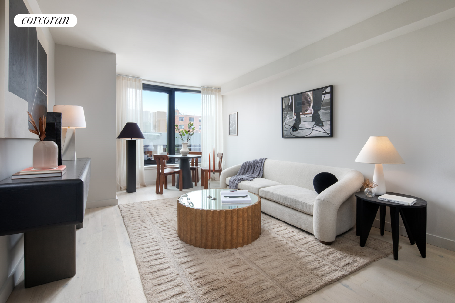 a living room with furniture and a large mirror next to a window