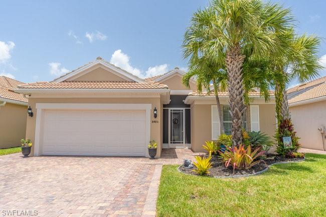 Mediterranean / spanish-style house featuring a front yard and a garage