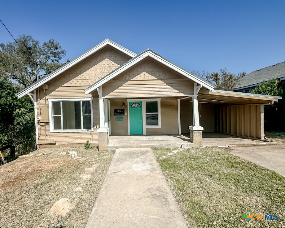 a front view of a house with a garden and yard