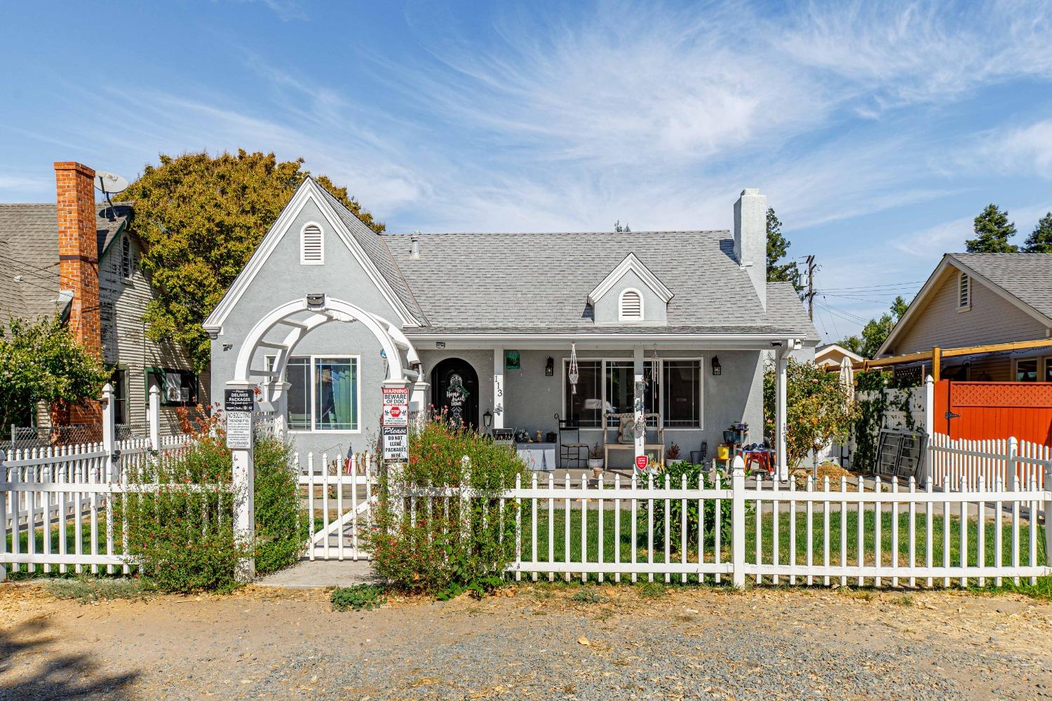 a front view of a house with a garden