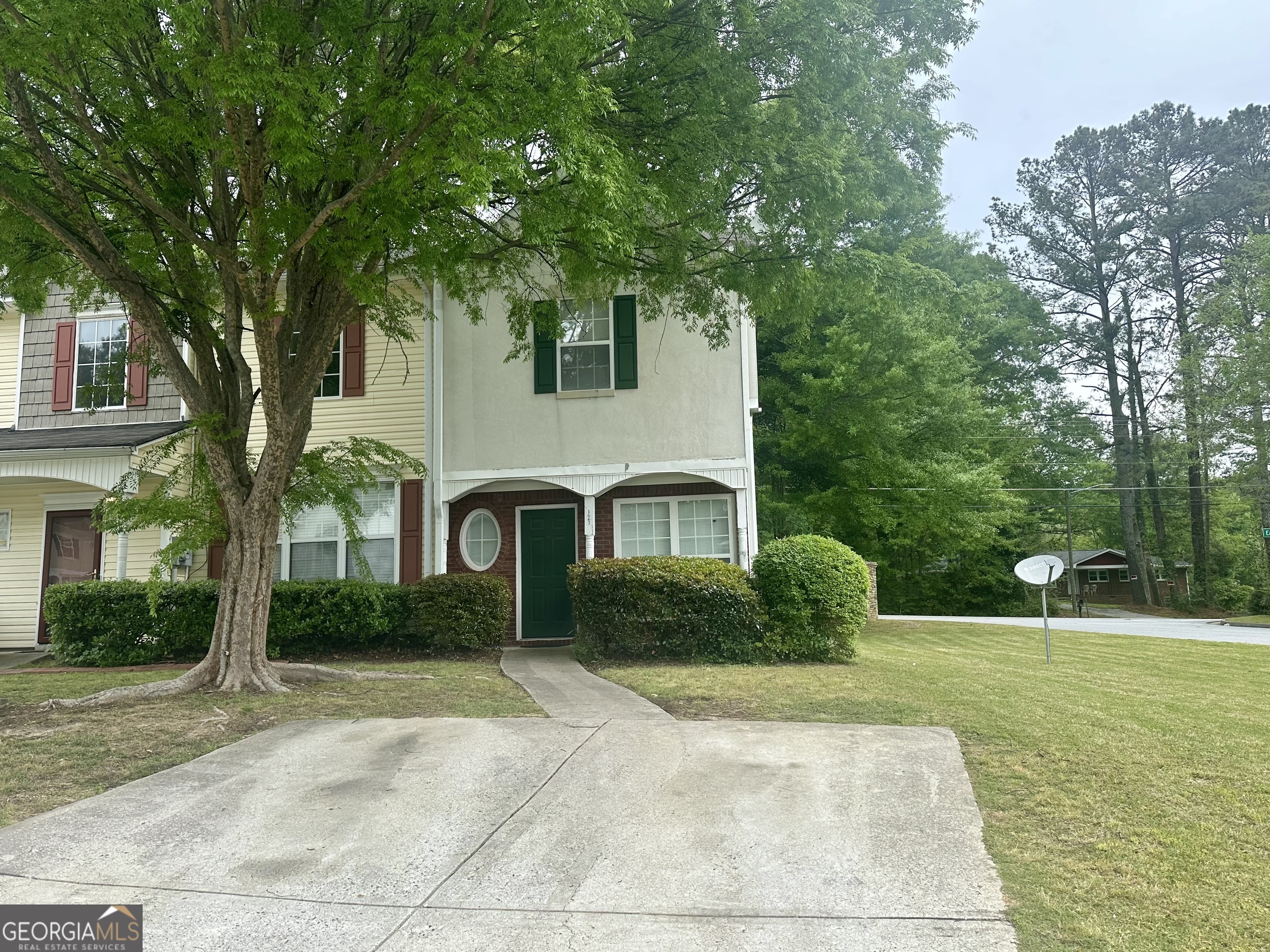 a front view of a house with garden