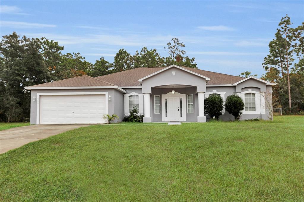 a front view of a house with a yard and garage