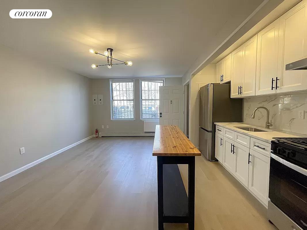 a kitchen with refrigerator and window