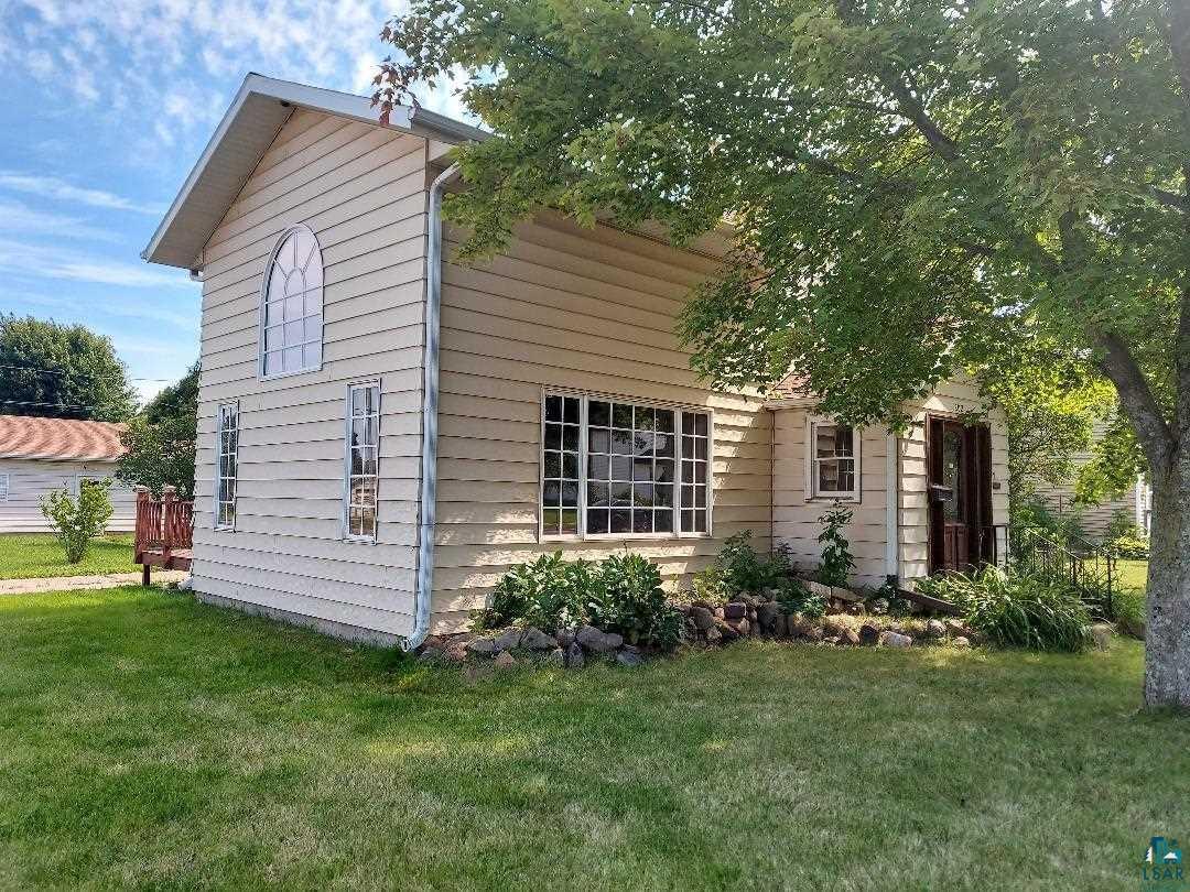 View of property exterior featuring a yard