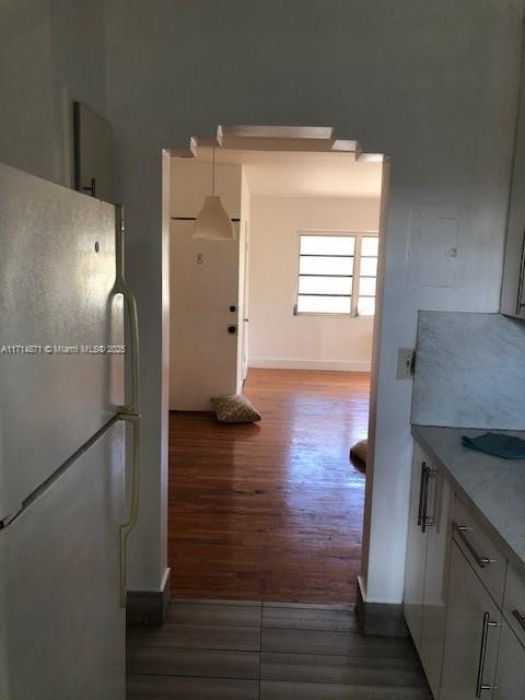 a kitchen with a refrigerator and a stove top oven