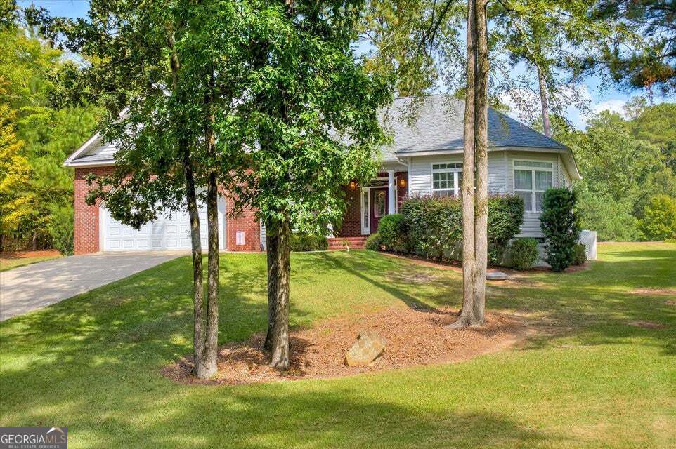 a view of a house with a tree in a yard