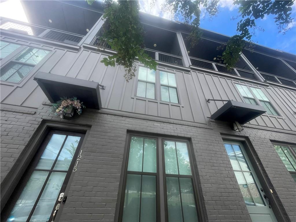 a view of balcony with a potted plant and floor to ceiling window