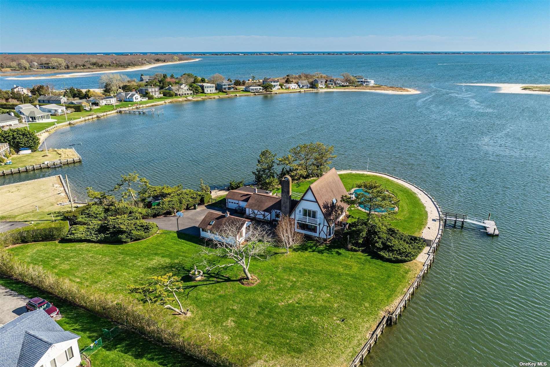 an aerial view of a house with a garden and lake view