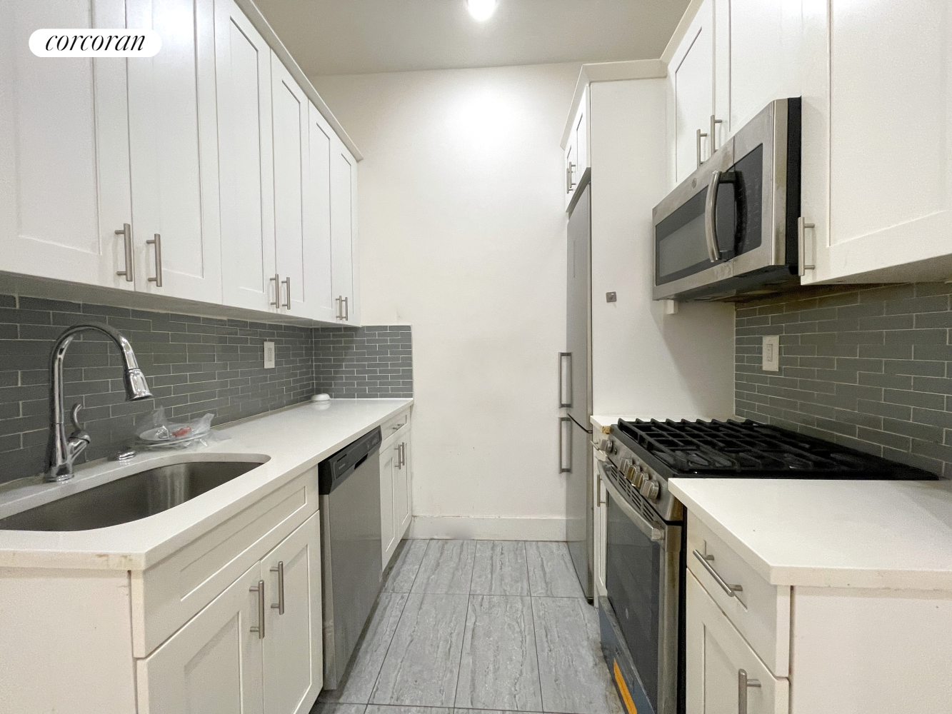 a kitchen with stainless steel appliances granite countertop a sink and a stove