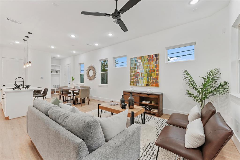 a living room with furniture potted plant and a window