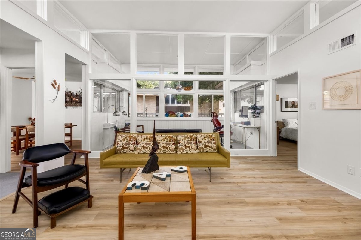 a living room with furniture and wooden floor