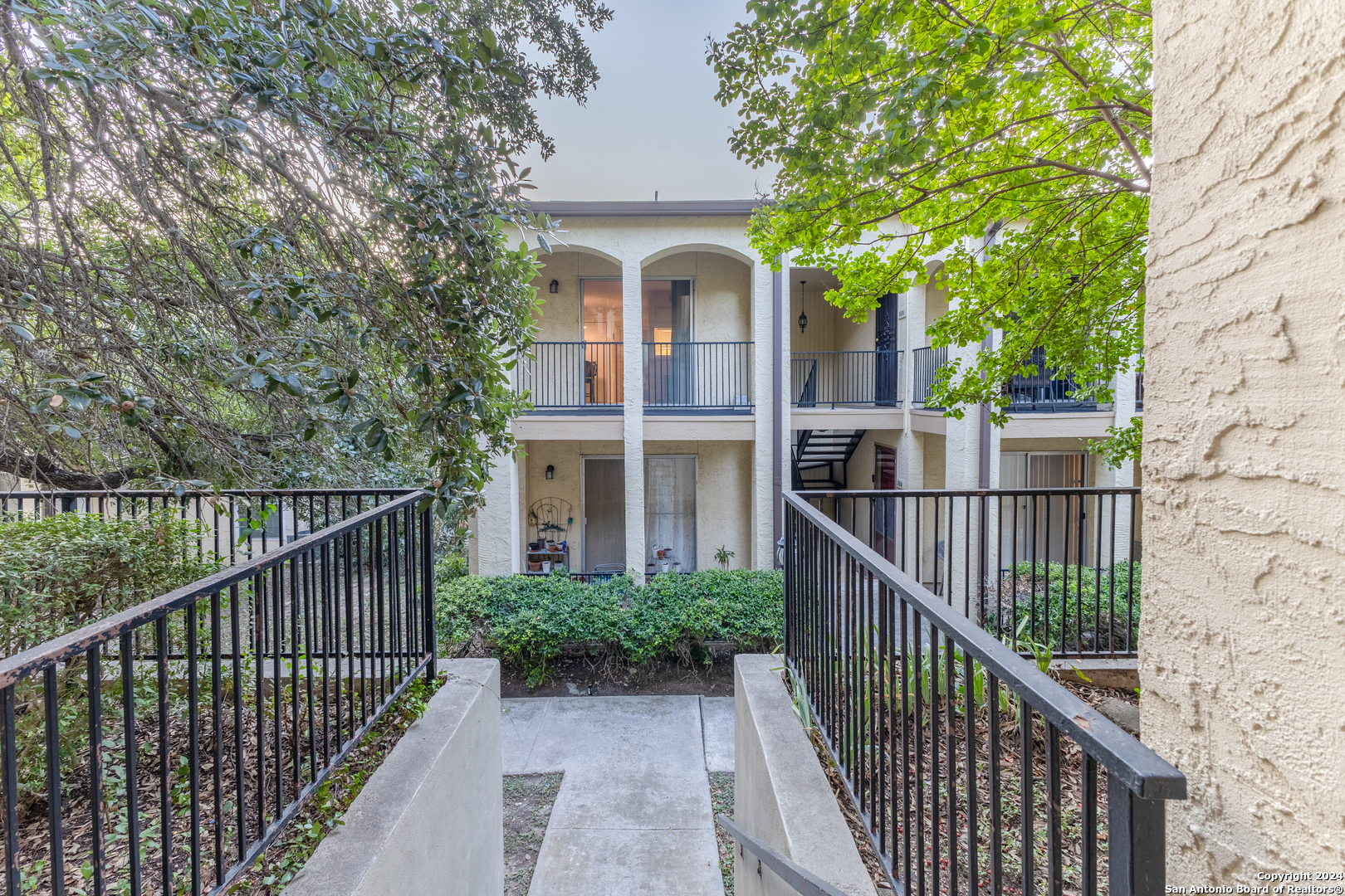 a view of a house with iron fence