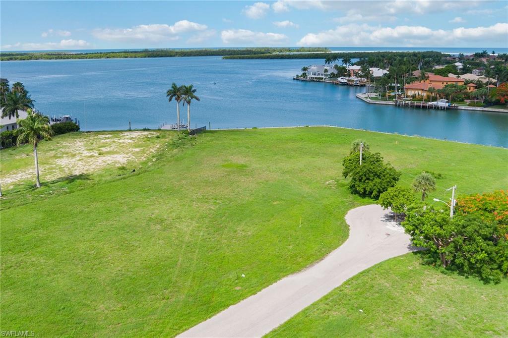 a view of a lake with lawn chairs