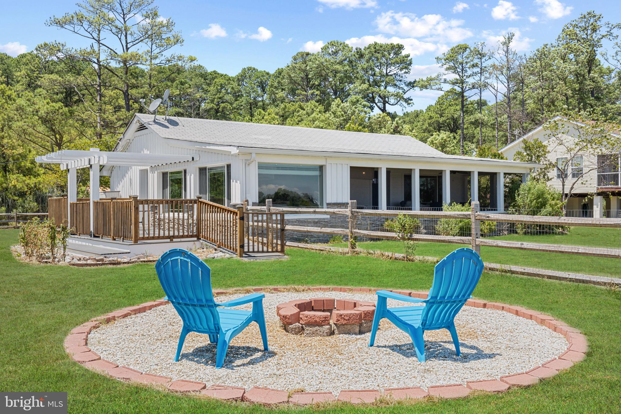 a backyard of a house with yard table and chairs