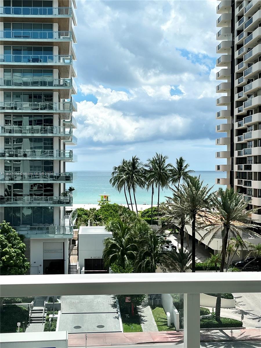 a view of balcony with tall buildings