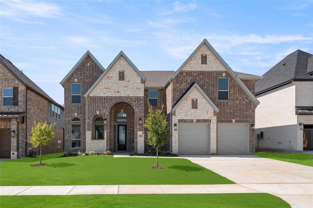 a front view of a house with a yard and garage