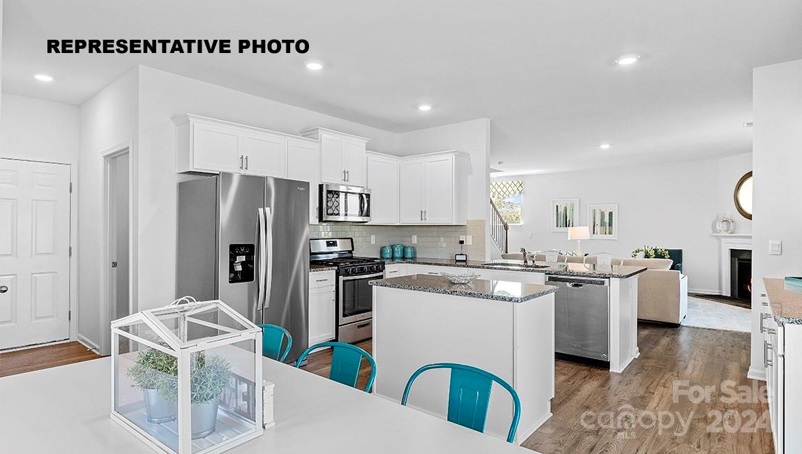 a kitchen that has a lot of cabinets and refrigerator