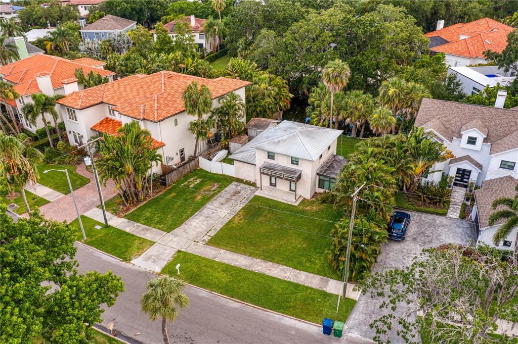 an aerial view of a house with garden space and street view