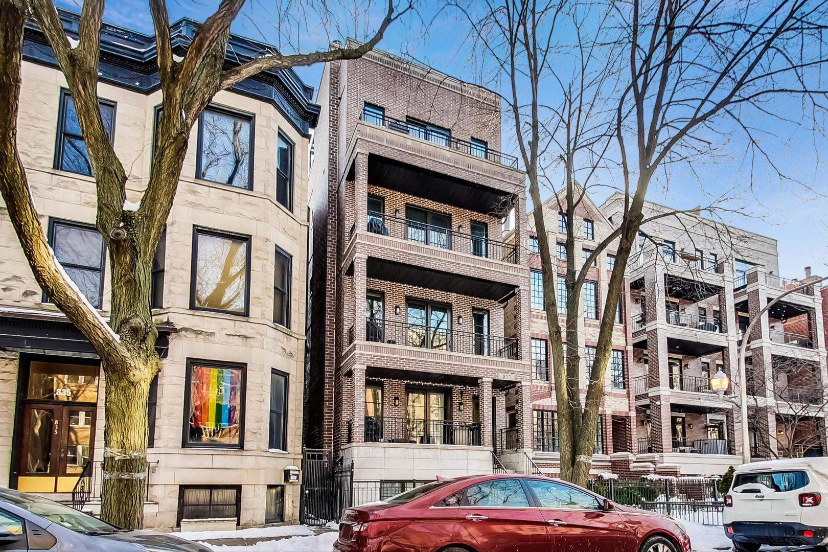 a front view of a residential apartment building with a yard