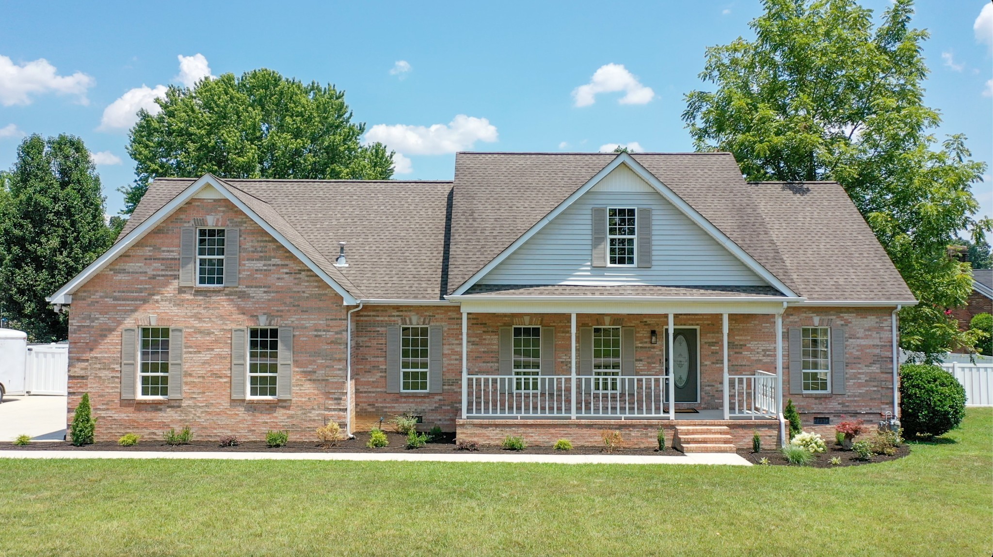 a front view of house with a garden