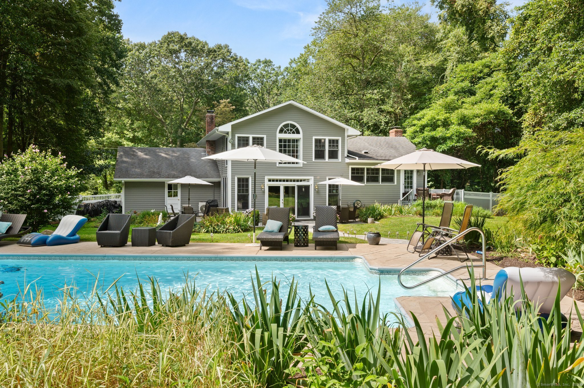 a front view of a house with garden and porch