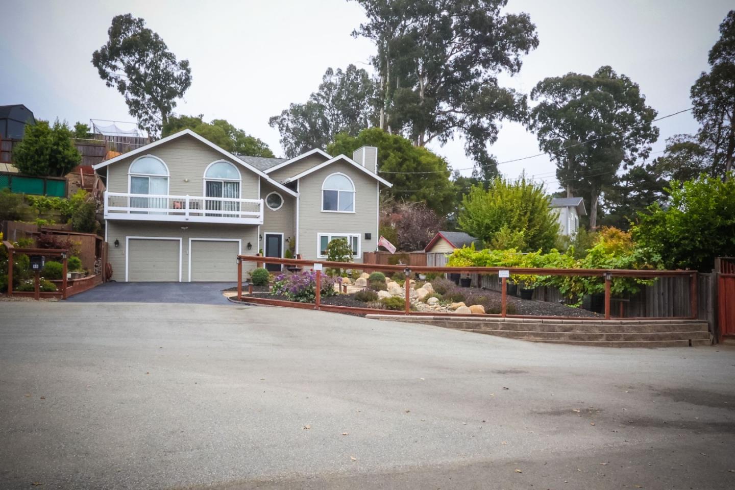 a view of a house with a patio and a yard