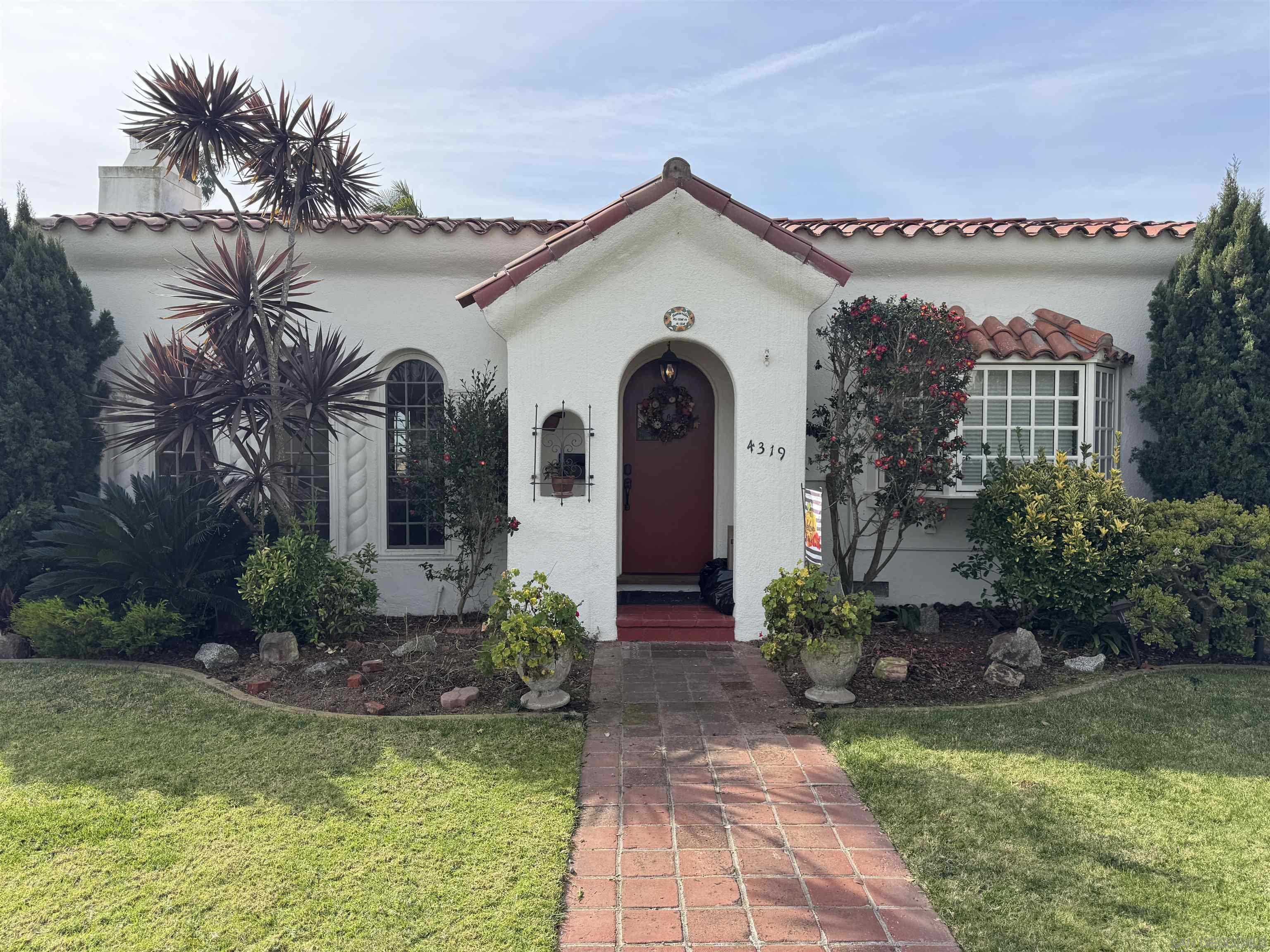 a front view of a house with garden