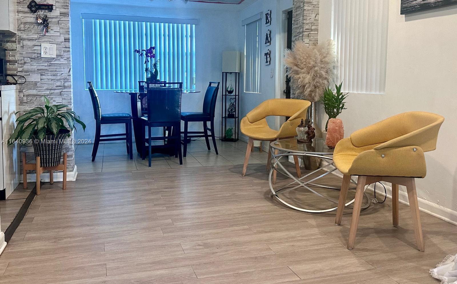 a view of a livingroom with furniture and wooden floor