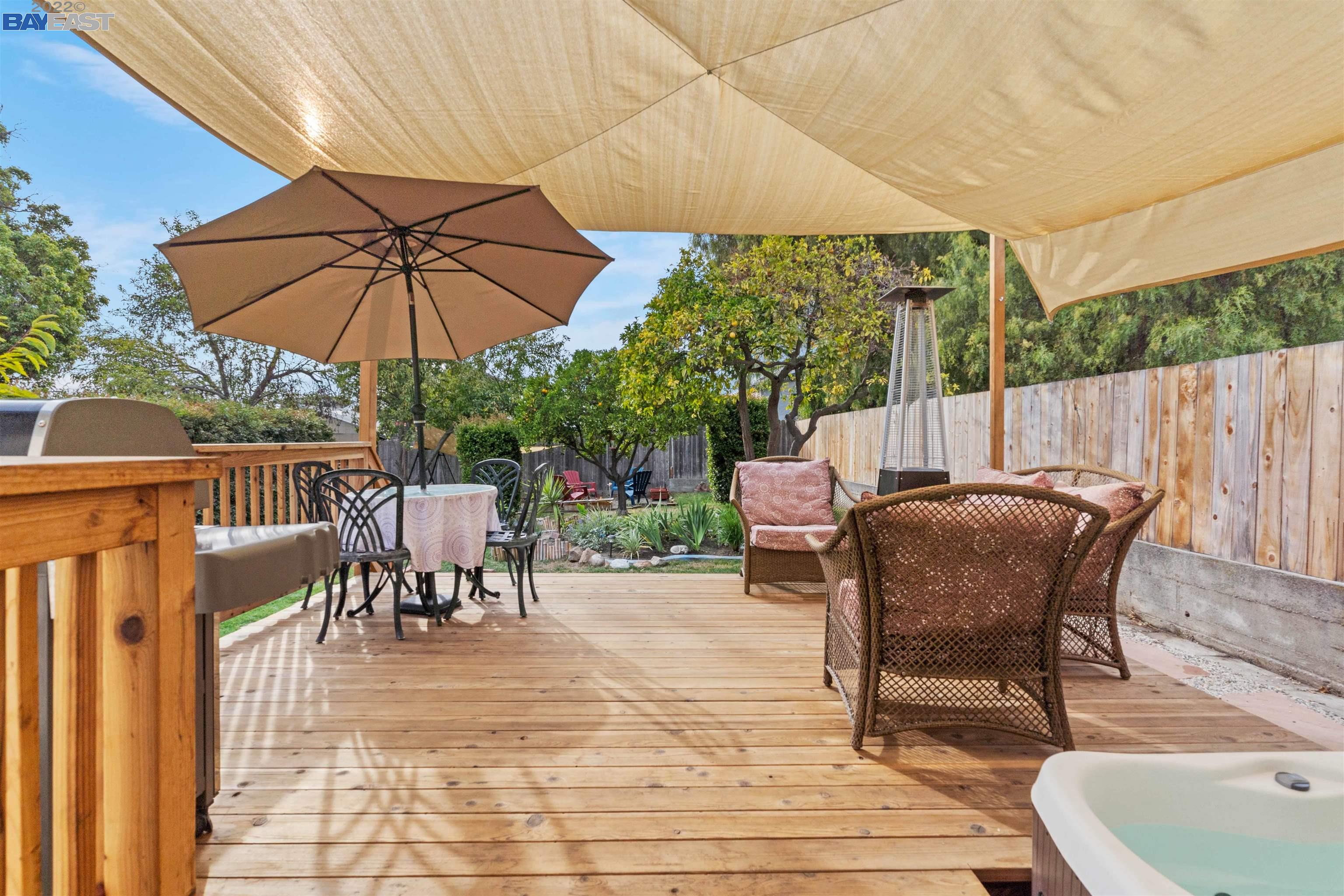 a view of a patio with a table chairs and a umbrella