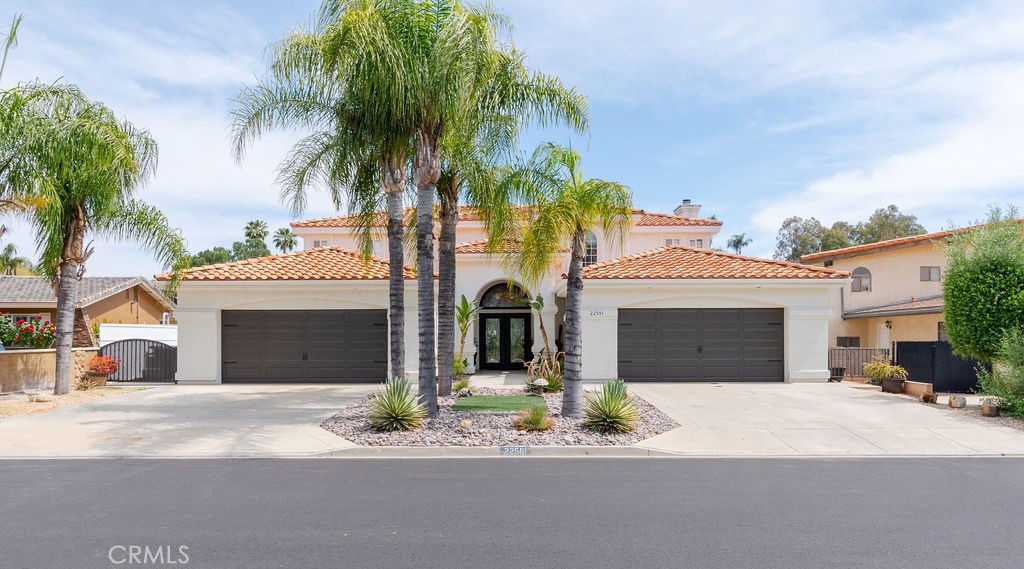 a front view of a house with yard and parking