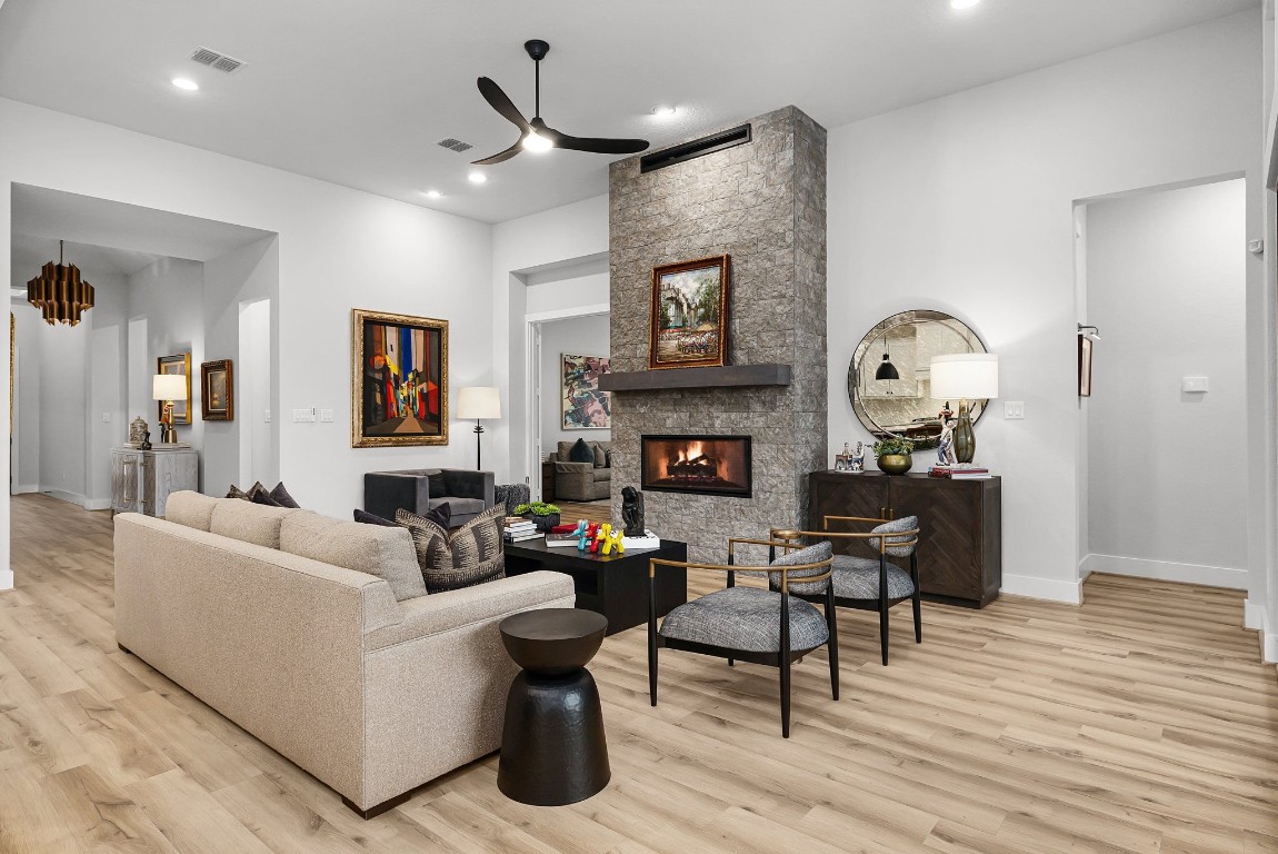 a living room with furniture a fireplace and a flat screen tv