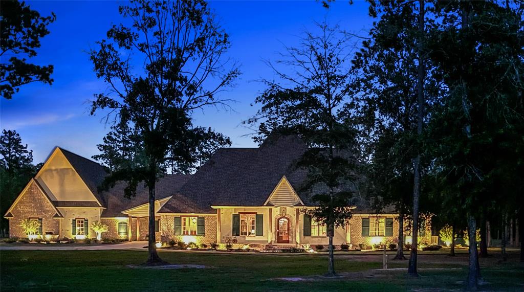 a view of big yard in front of house with trees