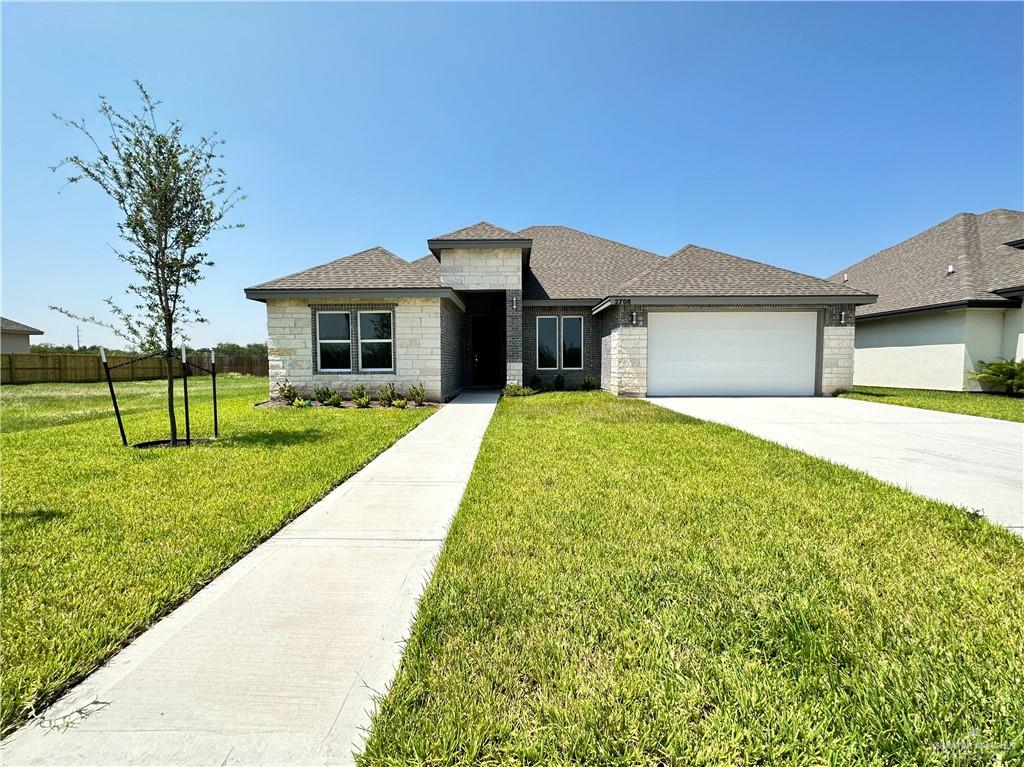 a front view of house with yard and green space