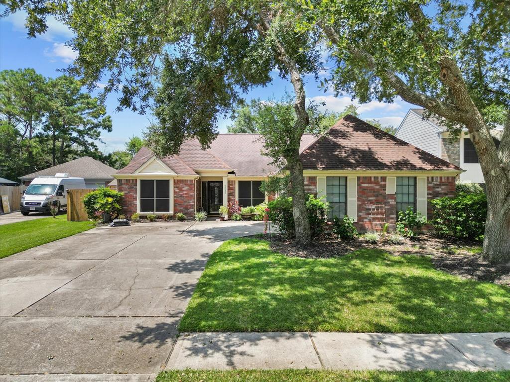 a front view of a house with yard patio and green space