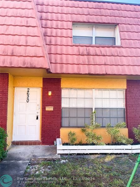 a view of a brick house with a yard