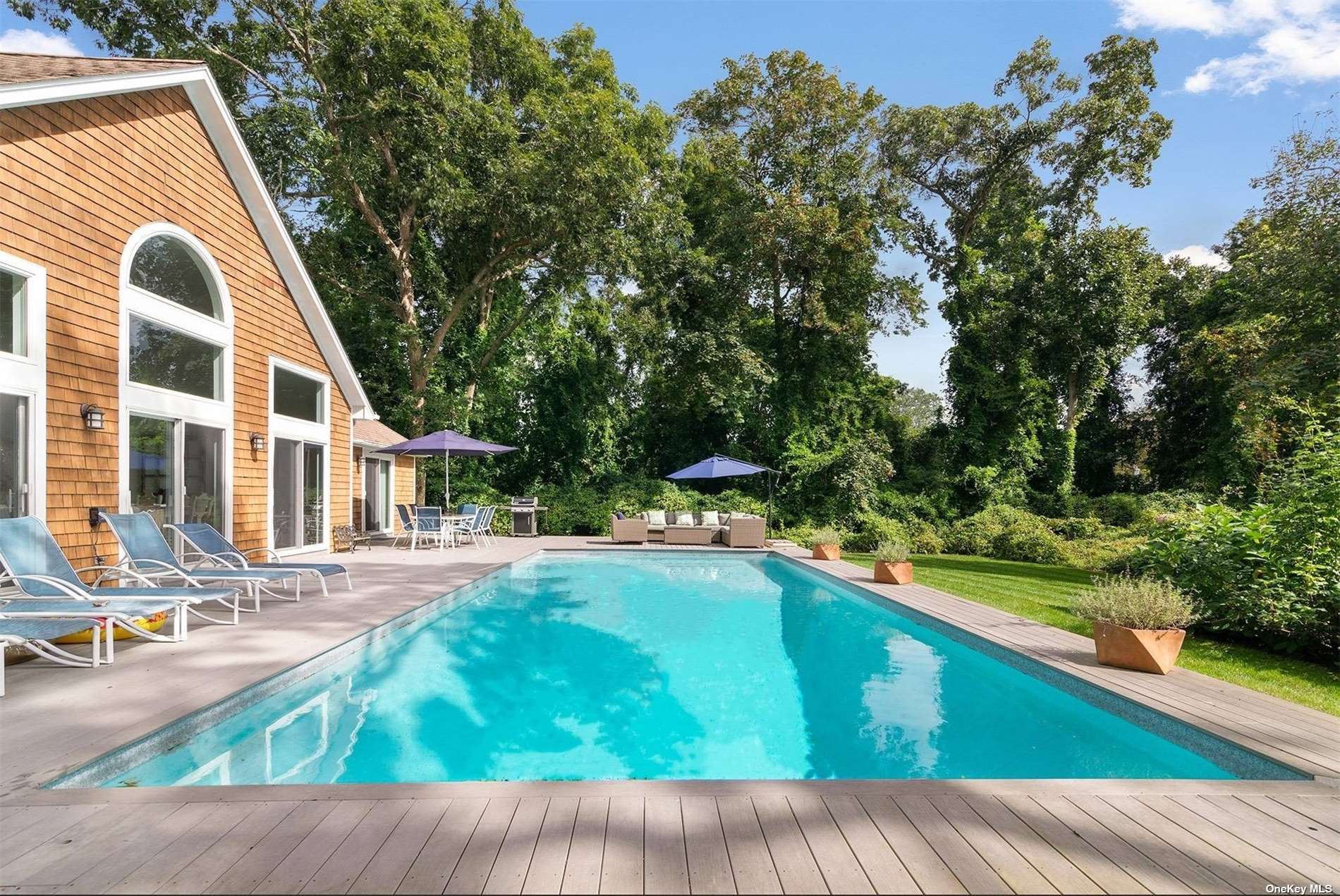 a view of backyard with swimming pool and outdoor seating