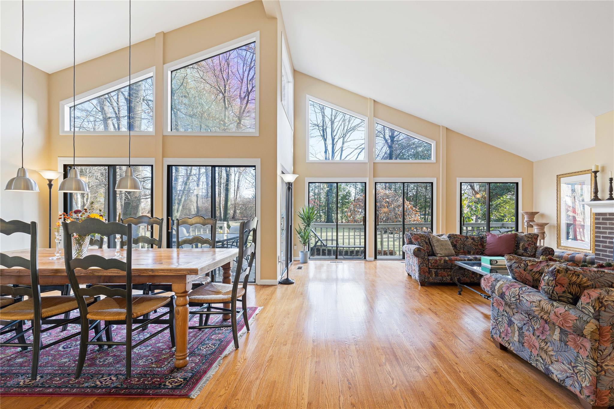 a living room with furniture a large window and wooden floor