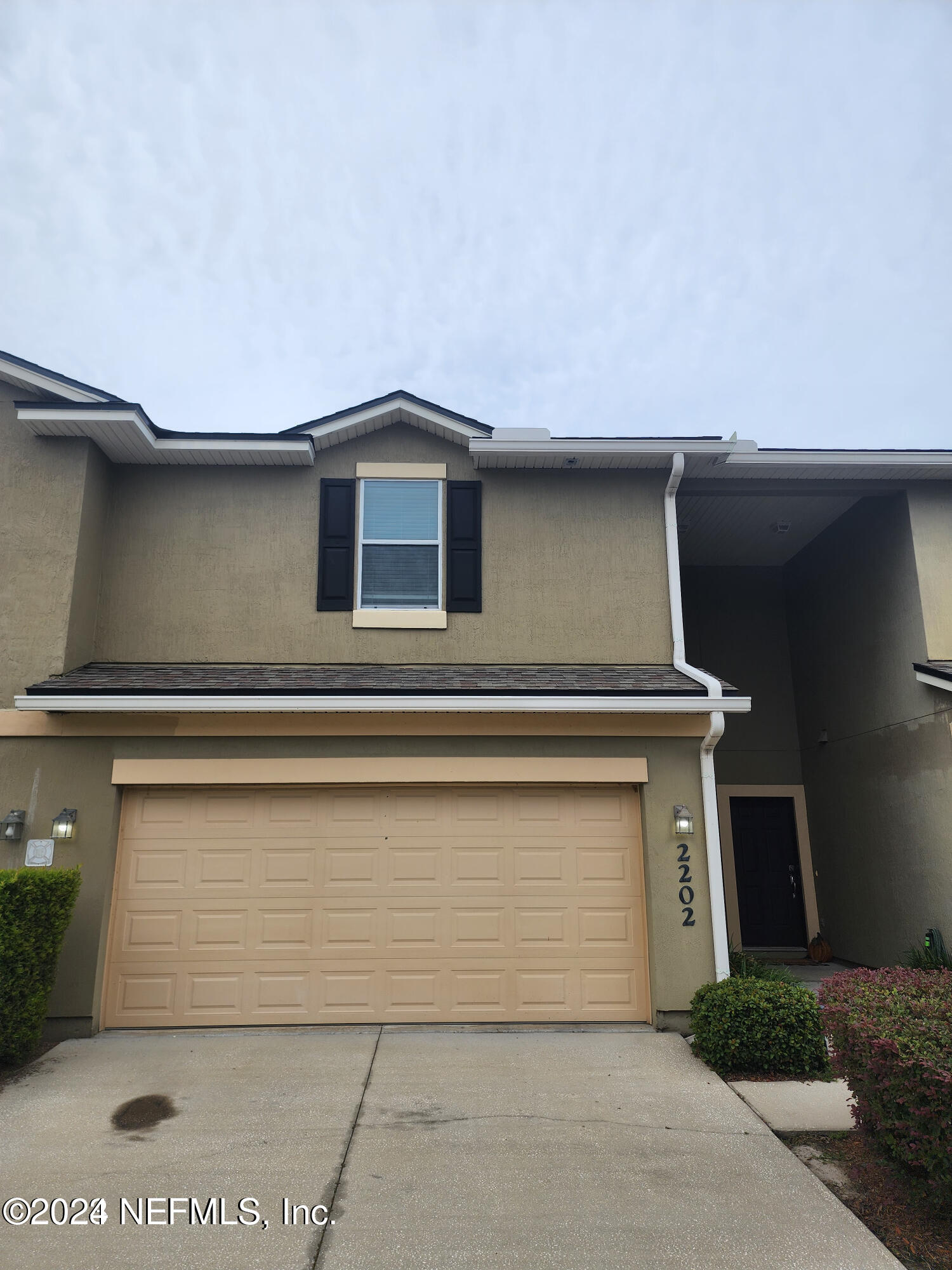 a front view of a house with a garage