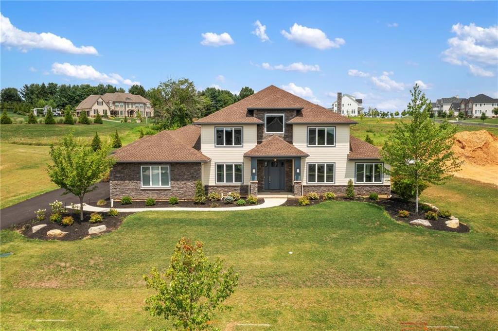 a view of a house with swimming pool and a yard