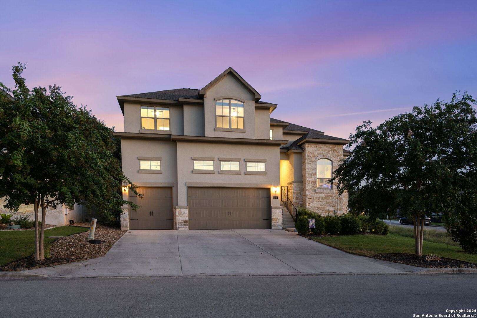 a front view of a house with a yard and garage