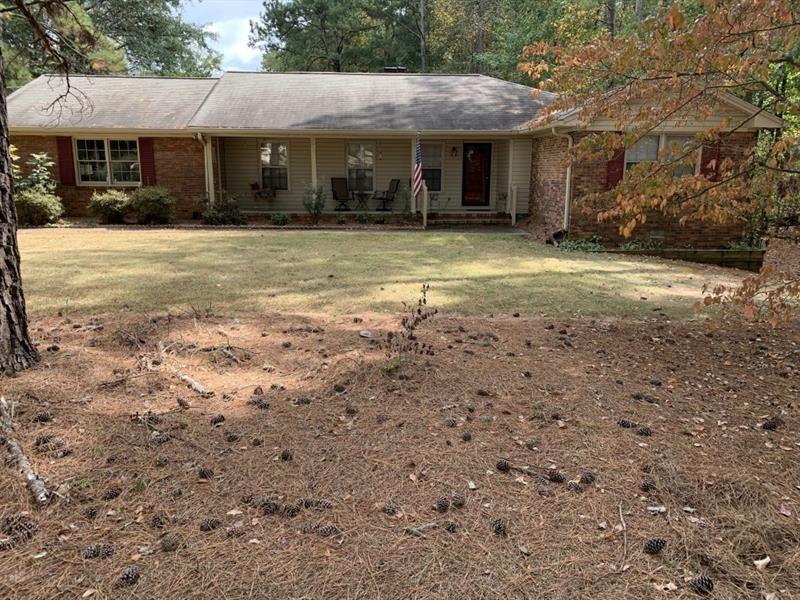 a view of a house with a yard and sitting area